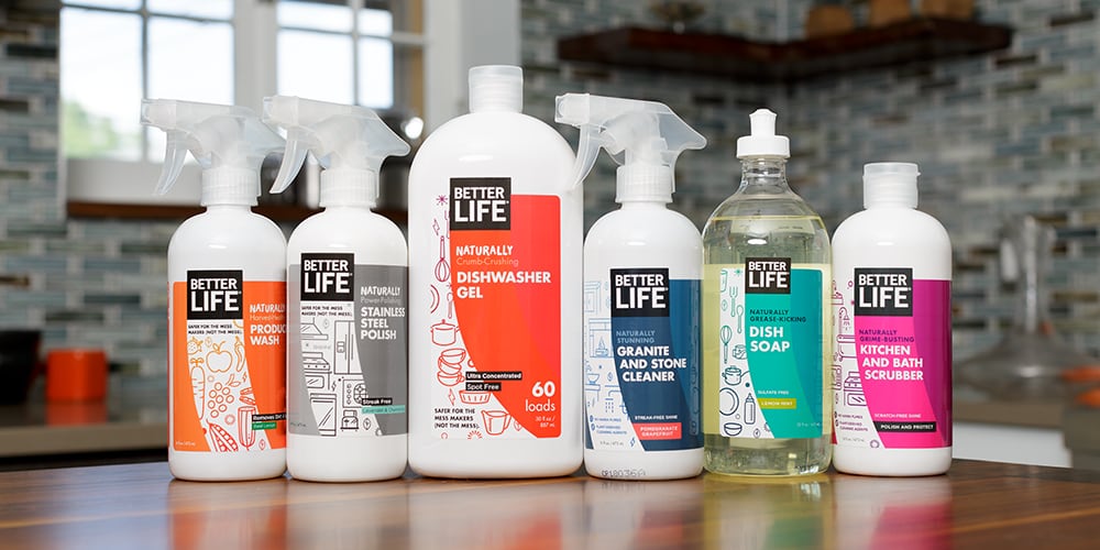 Six bottles of Better Life cleaning products on a table.