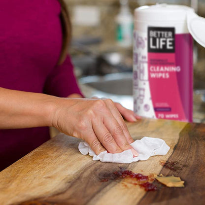 A lady cleaning surface with Better Life cleaning wipes - Pomegranate